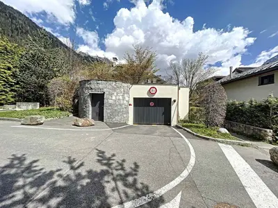 a garage in a house with a driveway at Appartement T3 au Centre de Chamonix avec WIFI et Parking - FR-1-507-3 in Chamonix-Mont-Blanc