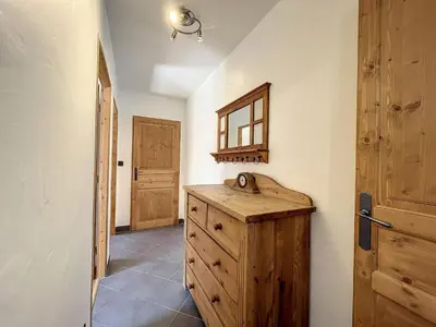 a room with a wooden cabinet and a door at Appartement T3 au Centre de Chamonix avec WIFI et Parking - FR-1-507-3 in Chamonix-Mont-Blanc