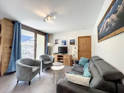a living room with a couch and chairs and a tv at Appartement T3 au Centre de Chamonix avec WIFI et Parking - FR-1-507-3 in Chamonix-Mont-Blanc