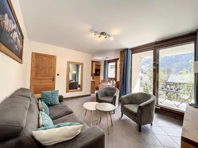 a living room with a couch and chairs and a table at Appartement T3 au Centre de Chamonix avec WIFI et Parking - FR-1-507-3 in Chamonix-Mont-Blanc
