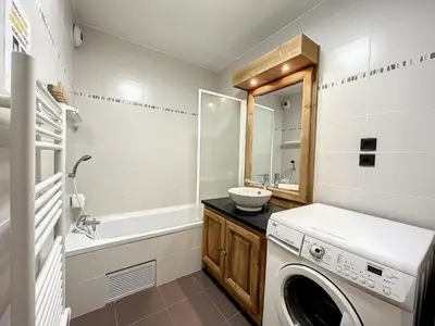 a bathroom with a washing machine and a sink at Chamonix centre, 64m², 6 pers., 2 chambres, parking - FR-1-507-14 in Chamonix-Mont-Blanc