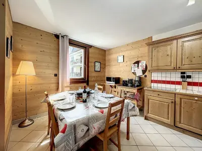 a kitchen with a table and chairs in a room at Chamonix centre, 64m², 6 pers., 2 chambres, parking - FR-1-507-14 in Chamonix-Mont-Blanc