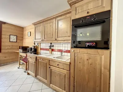 a kitchen with wooden cabinets and a sink at Chamonix centre, 64m², 6 pers., 2 chambres, parking - FR-1-507-14 in Chamonix-Mont-Blanc