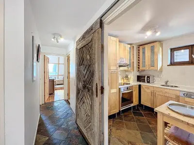 a kitchen with a large wooden door in a room at Chamonix: Appart 4 pers, Parking, Wifi - FR-1-507-24 in Chamonix-Mont-Blanc
