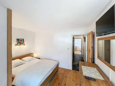 a bedroom with a bed and a flat screen tv at Chamonix: Appart 4 pers, Parking, Wifi - FR-1-507-24 in Chamonix-Mont-Blanc