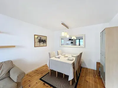 a dining room with a table and a couch at Chamonix: Appart 4 pers, Parking, Wifi - FR-1-507-24 in Chamonix-Mont-Blanc