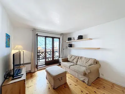 a living room with a couch and a tv at Chamonix: Appart 4 pers, Parking, Wifi - FR-1-507-24 in Chamonix-Mont-Blanc