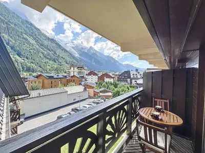 a balcony with a table and a view of a city at Chamonix: Appart 4 pers, Parking, Wifi - FR-1-507-24 in Chamonix-Mont-Blanc
