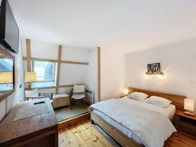a bedroom with a bed and a desk and a television at Chamonix: Appart 4 pers, Parking, Wifi - FR-1-507-24 in Chamonix-Mont-Blanc