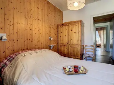 a bedroom with a bed with a tray of food on it at Appartement spacieux à Chamonix, 8 pers, ascenseur - FR-1-507-25 in Chamonix-Mont-Blanc