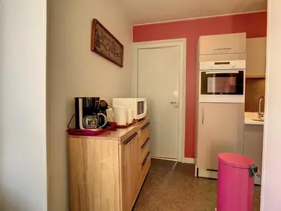 a kitchen with a counter with a microwave and a refrigerator at Appartement spacieux à Chamonix, 8 pers, ascenseur - FR-1-507-25 in Chamonix-Mont-Blanc