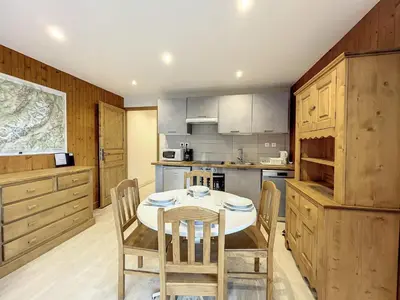 a kitchen with a table and chairs in it at Appartement Chaleureux à Chamonix, 4 Pers, Près du Brévent avec Terrasse et Parking - FR-1-507-26 in Chamonix-Mont-Blanc
