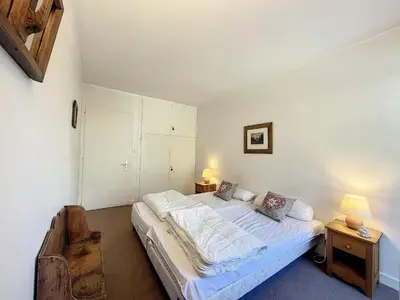 a bedroom with a large bed and two night stands at T2 spacieux 45m² pour 4 pers, centre Chamonix, parking inclus - FR-1-507-27 in Chamonix-Mont-Blanc