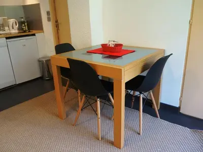 a table with chairs and a bowl on top of it at Appartement cosy au centre de Chamonix avec jardin, 2 pièces, bien équipé, accepte animaux - FR-1-507-29 in Chamonix-Mont-Blanc