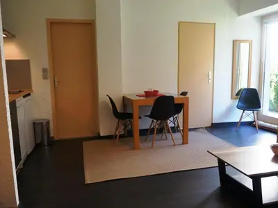 a living room with a table and chairs at Appartement cosy au centre de Chamonix avec jardin, 2 pièces, bien équipé, accepte animaux - FR-1-507-29 in Chamonix-Mont-Blanc