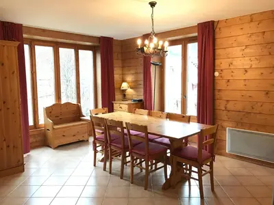 a dining room with a wooden table and chairs at Appartement de standing Chamonix 4 pers, parking/ski - FR-1-507-34 in Chamonix-Mont-Blanc