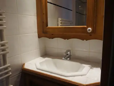 a bathroom with a white sink and a mirror at Appartement de standing Chamonix 4 pers, parking/ski - FR-1-507-34 in Chamonix-Mont-Blanc