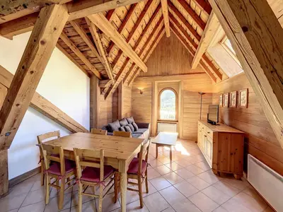 a dining room with a table and chairs in a cabin at Chamonix: Appart. standing 6 pers, 3 ch, parking, centre-ville - FR-1-507-35 in Chamonix-Mont-Blanc