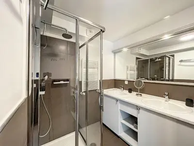 a bathroom with two sinks and a glass shower at Appartement rénové à Chamonix, balcon, parking - FR-1-507-37 in Chamonix-Mont-Blanc