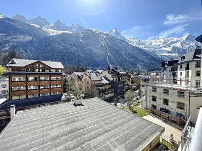 a view of a city with snow covered mountains at Appartement rénové à Chamonix, balcon, parking - FR-1-507-37 in Chamonix-Mont-Blanc