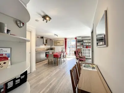 a kitchen and living room with a table and chairs at Appartement rénové à Chamonix, balcon, parking - FR-1-507-37 in Chamonix-Mont-Blanc