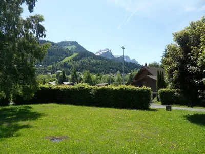 a park with a field of grass and a street light at Appartement les Carroz d'Arraches in Les Carroz d'Araches