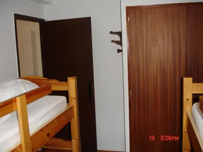 a small bedroom with a bed and a mirror at Appartement les Carroz d'Arraches in Les Carroz d'Araches