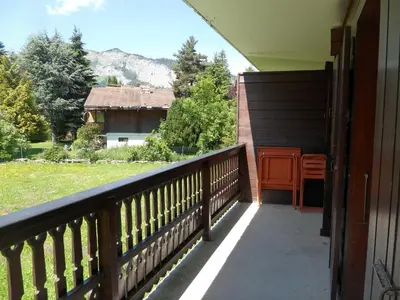 a living room with a fireplace and red curtains at Appartement les Carroz d'Arraches in Les Carroz d'Araches