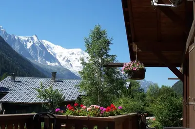 a balcony with a view of a snow covered mountain at Chalet * Lioutraz * in Chamonix-Mont-Blanc