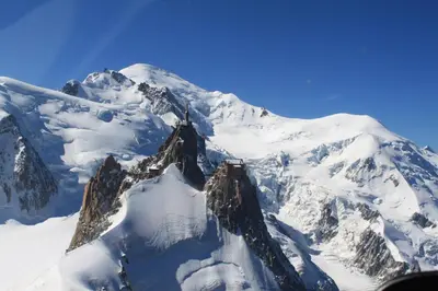 a mountain covered in snow and ice with a plane at Chalet * Lioutraz * in Chamonix-Mont-Blanc