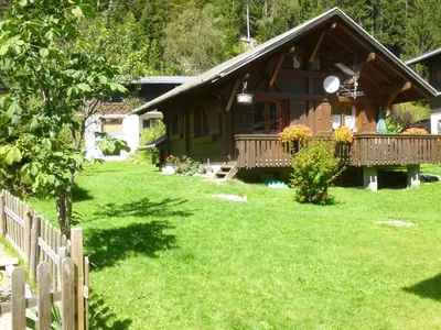 a house with a fence in front of a yard at Chalet * Lioutraz * in Chamonix-Mont-Blanc