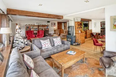 a living room with a couch and a christmas tree at Au Vieux Moulin in Megève