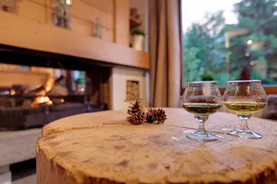 two glasses of wine sitting on a wooden table at Les Campanules in Les Houches