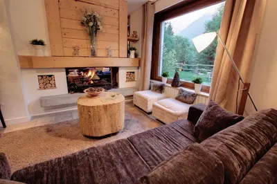 a living room with a couch and a fireplace at Les Campanules in Les Houches