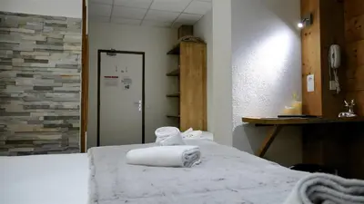 a room with a bed with two towels on it at Les Campanules in Les Houches