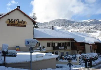 a ski lodge with snow on the roof at Hotel Val Joly in Saint-Gervais-les-Bains