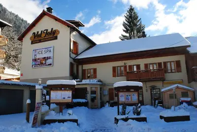 a ski lodge with snow on the ground at Hotel Val Joly in Saint-Gervais-les-Bains