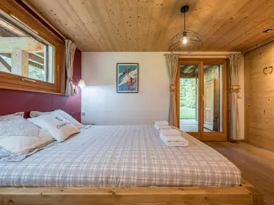 a bedroom with a bed with towels on it at Chalet CLADIE - Private Jacuzzi & Sauna - View of Mont Blanc range - By Cozee Rentals in Les Houches