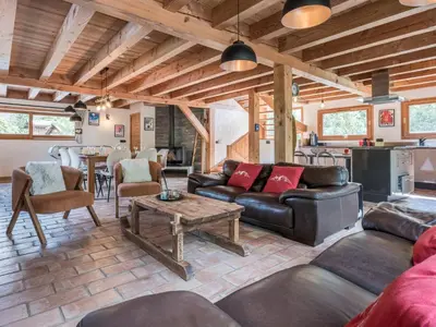a living room with a couch and a table at Chalet CLADIE - Private Jacuzzi & Sauna - View of Mont Blanc range - By Cozee Rentals in Les Houches