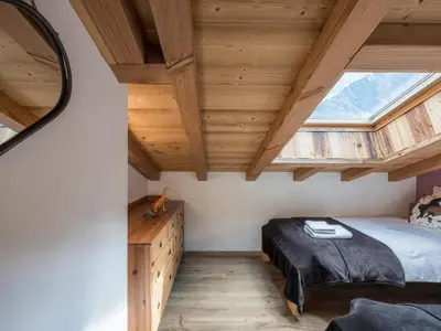 a bedroom with a bed and a large window at Chalet CLADIE - Private Jacuzzi & Sauna - View of Mont Blanc range - By Cozee Rentals in Les Houches