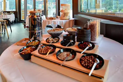 a buffet with different types of food on a table at Alpina Eclectic Hotel in Chamonix-Mont-Blanc