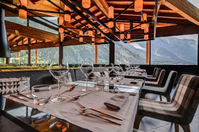 a dining room with a table with wine glasses at Alpina Eclectic Hotel in Chamonix-Mont-Blanc