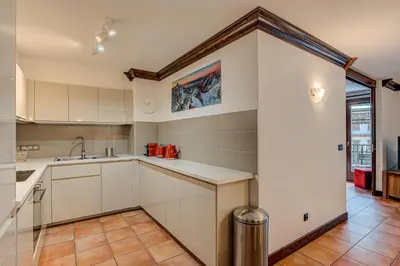 a kitchen with white cabinets and a sink at APARTMENT KITSON - Alpes Travel - Chamonix - Sleeps 6 in Chamonix-Mont-Blanc
