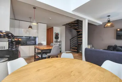 a kitchen and dining room with a table and chairs at Maison Des Praz Chamonix in Chamonix-Mont-Blanc