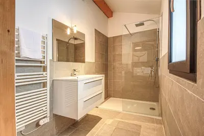 a bathroom with a sink and a shower at Maison Des Praz Chamonix in Chamonix-Mont-Blanc