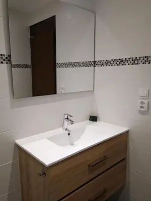 a bathroom with a sink and a mirror at Le Si-près Pied des pistes in Les Carroz d'Araches