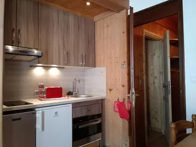 a small kitchen with a sink and a stove at Le Si-près Pied des pistes in Les Carroz d'Araches