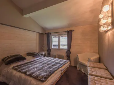 a bedroom with a large bed and a window at Duplex 6 pers, Animaux admis, Parking, Vue Mont Blanc - FR-1-517-11 in Chamonix-Mont-Blanc