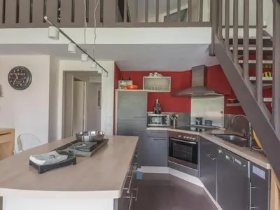 a kitchen with gray cabinets and red walls at Duplex 6 pers, Animaux admis, Parking, Vue Mont Blanc - FR-1-517-11 in Chamonix-Mont-Blanc