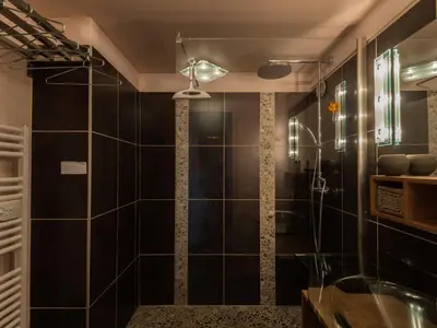 a bathroom with a shower with black tiles at Duplex 6 pers, Animaux admis, Parking, Vue Mont Blanc - FR-1-517-11 in Chamonix-Mont-Blanc